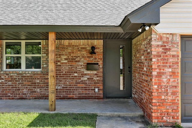 1317 E Boyd St, Norman, OK 73071 - entrance to property featuring roof with shingles and brick siding