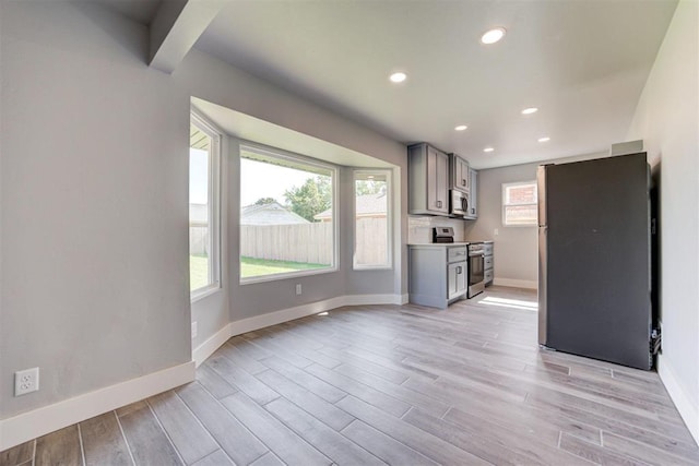 1317 E Boyd St, Norman, OK 73071 - unfurnished living room with light wood-style floors and recessed lighting