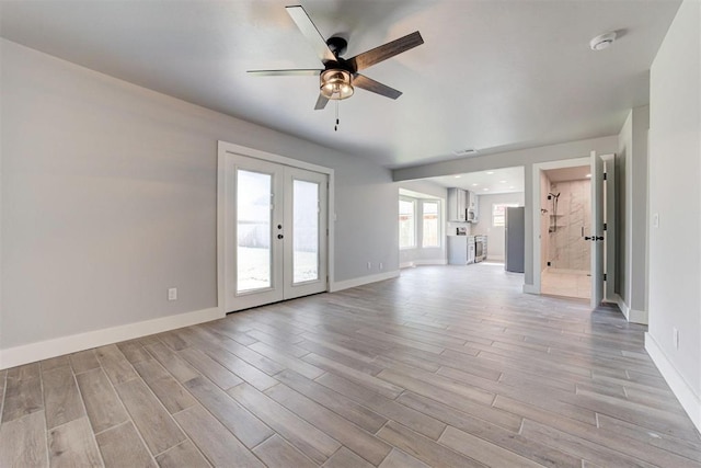 1317 E Boyd St, Norman, OK 73071 - unfurnished living room with french doors, ceiling fan, and light wood-style floors
