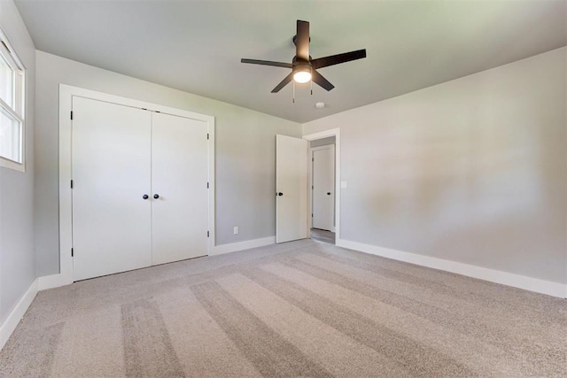1317 E Boyd St, Norman, OK 73071 - unfurnished bedroom featuring light carpet, a closet, and ceiling fan