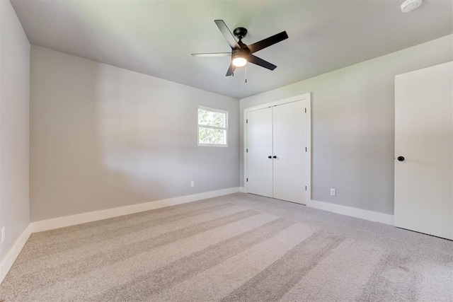 1317 E Boyd St, Norman, OK 73071 - unfurnished bedroom with light colored carpet, a ceiling fan, and a closet