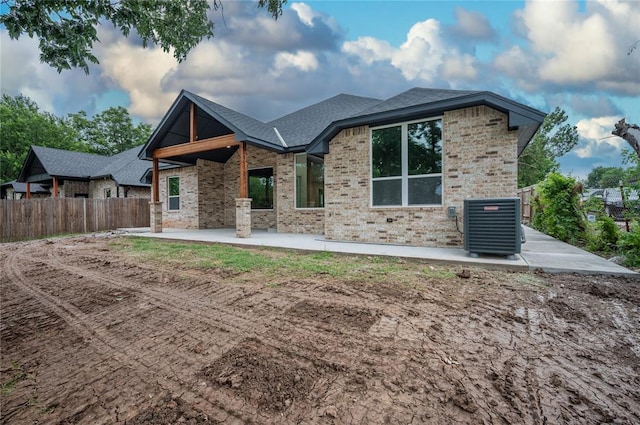 2705 NW 40th St, Oklahoma City, OK 73112 - view of front of house featuring a patio, brick siding, and roof with shingles