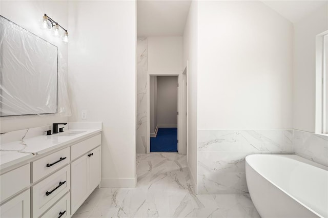 2705 NW 40th St, Oklahoma City, OK 73112 - bathroom with vanity, a freestanding tub, marble finish flooring, and a wainscoted wall