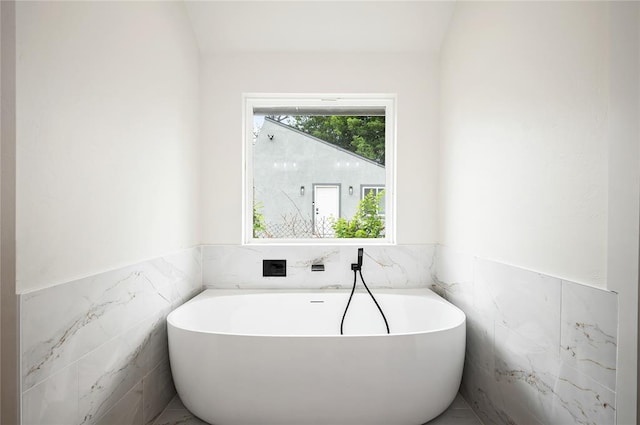 2705 NW 40th St, Oklahoma City, OK 73112 - full bath featuring tile walls, a freestanding bath, and wainscoting