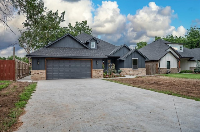 2705 NW 40th St, Oklahoma City, OK 73112 - craftsman house featuring a shingled roof, concrete driveway, an attached garage, and board and batten siding