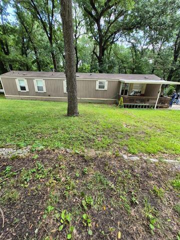 2908 Harber Loop, Grove, OK 74020 - view of front of home with a front lawn and view of scattered trees
