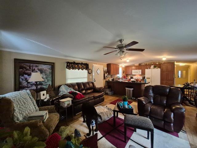 2908 Harber Loop, Grove, OK 74020 - living room featuring vaulted ceiling, ceiling fan, light wood-type flooring, and ornamental molding
