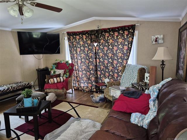 2908 Harber Loop, Grove, OK 74020 - living area with wood finished floors, a ceiling fan, ornamental molding, and lofted ceiling
