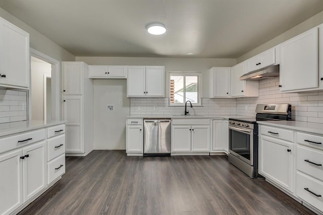 3325 NW 65th St Unit 4057723241, Oklahoma City, OK 73116 - kitchen featuring appliances with stainless steel finishes, under cabinet range hood, backsplash, white cabinetry, and light countertops