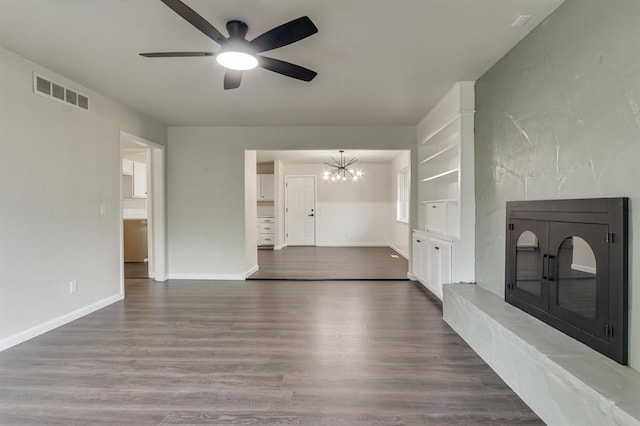 3325 NW 65th St Unit 4057723241, Oklahoma City, OK 73116 - unfurnished living room featuring a ceiling fan, dark wood-type flooring, and a chandelier