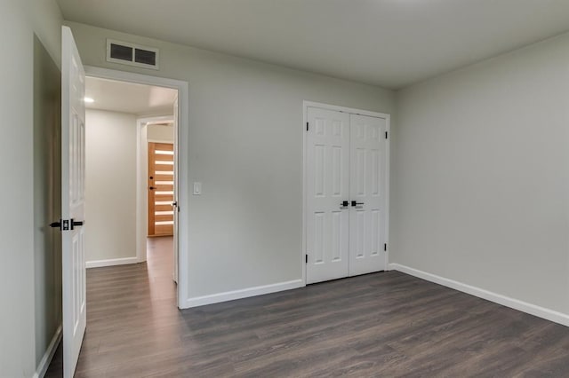 3325 NW 65th St Unit 4057723241, Oklahoma City, OK 73116 - unfurnished bedroom with dark wood-style flooring and a closet