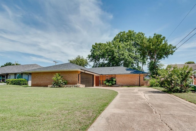 3325 NW 65th St Unit 4057723241, Oklahoma City, OK 73116 - view of front of home featuring brick siding, a front lawn, an attached garage, and driveway