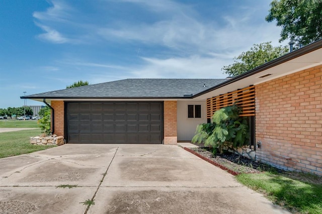 3325 NW 65th St Unit 4057723241, Oklahoma City, OK 73116 - view of front of house with brick siding, driveway, a garage, and a shingled roof