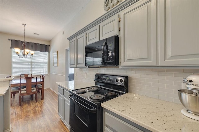 2725 NW 162nd St, Edmond, OK 73013 - kitchen featuring black appliances, gray cabinets, a chandelier, light wood-style floors, and tasteful backsplash