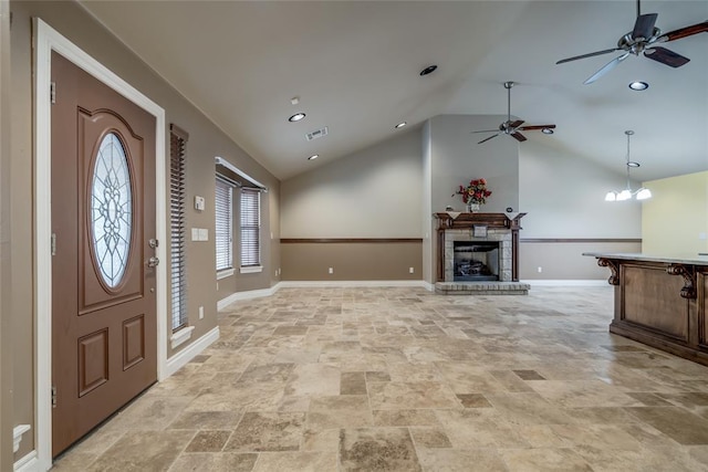 6704 Tall Oaks Dr, Oklahoma City, OK 73127 - entrance foyer featuring vaulted ceiling, ceiling fan, light stone finish flooring, a fireplace with raised hearth, and recessed lighting
