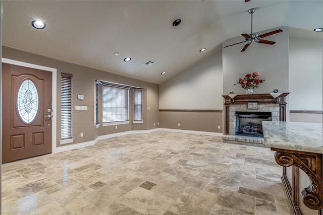 6704 Tall Oaks Dr, Oklahoma City, OK 73127 - entryway with lofted ceiling, healthy amount of natural light, a ceiling fan, light stone finish flooring, and a fireplace