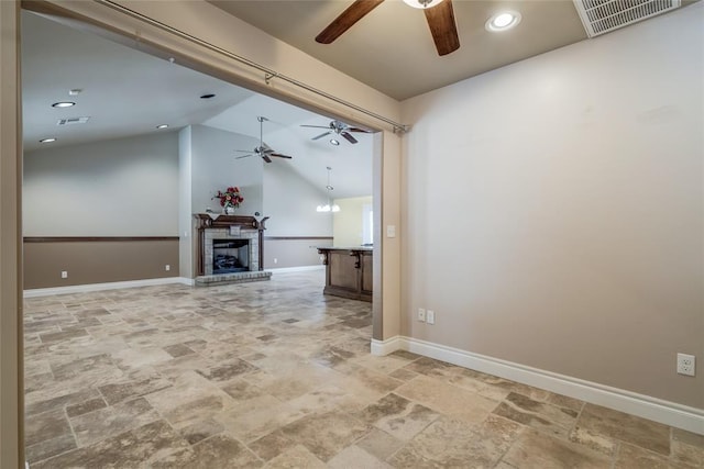 6704 Tall Oaks Dr, Oklahoma City, OK 73127 - unfurnished living room featuring a ceiling fan, stone finish flooring, lofted ceiling, recessed lighting, and a fireplace with raised hearth