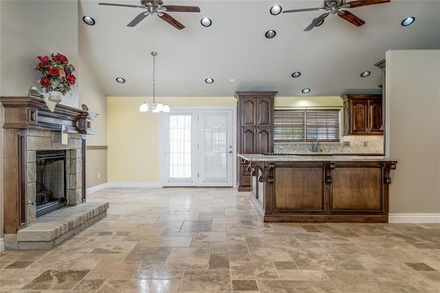 6704 Tall Oaks Dr, Oklahoma City, OK 73127 - kitchen featuring ceiling fan, stone tile floors, healthy amount of natural light, recessed lighting, and high vaulted ceiling