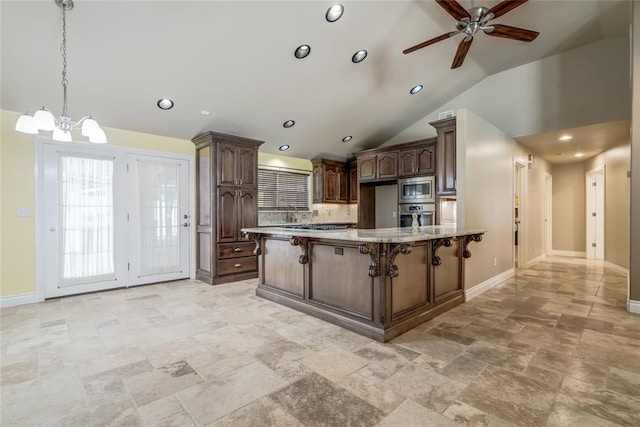 6704 Tall Oaks Dr, Oklahoma City, OK 73127 - kitchen featuring stainless steel appliances, stone tile flooring, tasteful backsplash, a kitchen breakfast bar, and a chandelier