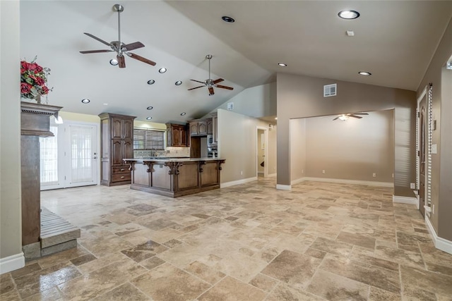 6704 Tall Oaks Dr, Oklahoma City, OK 73127 - kitchen featuring open floor plan, a ceiling fan, stone tile floors, high vaulted ceiling, and a kitchen island
