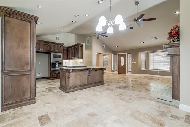 6704 Tall Oaks Dr, Oklahoma City, OK 73127 - kitchen featuring appliances with stainless steel finishes, a ceiling fan, open floor plan, vaulted ceiling, and pendant lighting