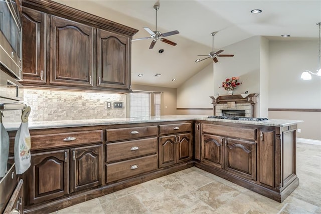 6704 Tall Oaks Dr, Oklahoma City, OK 73127 - kitchen featuring a ceiling fan, appliances with stainless steel finishes, vaulted ceiling, decorative backsplash, and a fireplace
