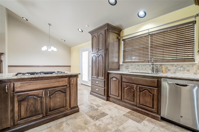 6704 Tall Oaks Dr, Oklahoma City, OK 73127 - kitchen with appliances with stainless steel finishes, vaulted ceiling, dark brown cabinetry, a chandelier, and backsplash
