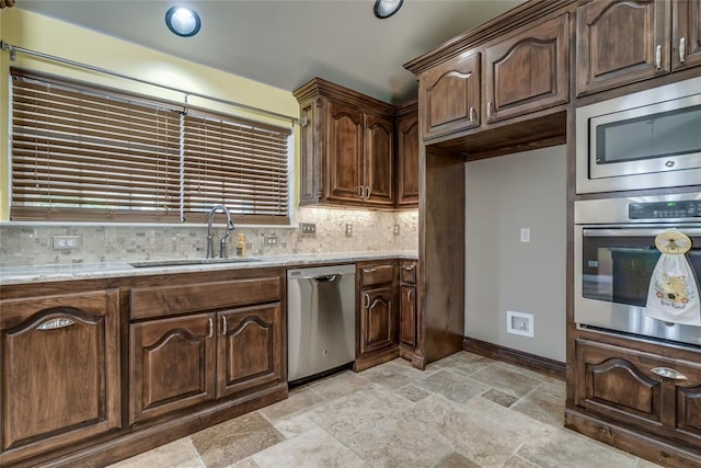 6704 Tall Oaks Dr, Oklahoma City, OK 73127 - kitchen featuring appliances with stainless steel finishes, backsplash, light stone countertops, and stone tile floors