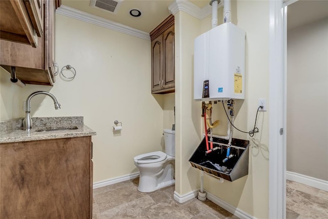 6704 Tall Oaks Dr, Oklahoma City, OK 73127 - half bath featuring tankless water heater, vanity, and ornamental molding