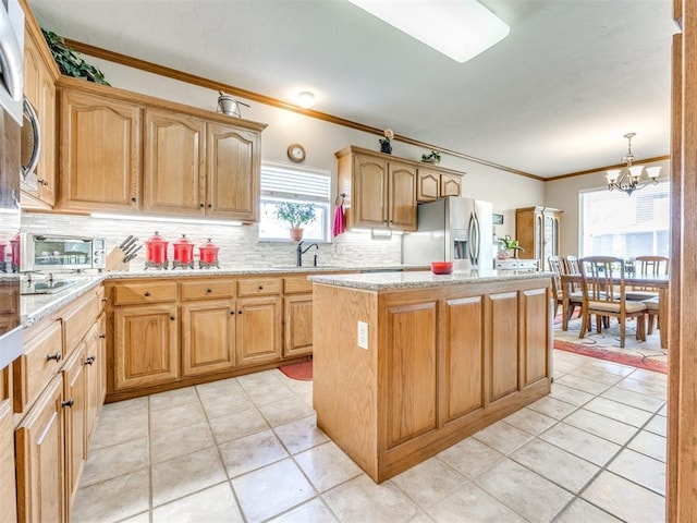 1405 Cambridge Ct, Shawnee, OK 74804 - kitchen with stainless steel fridge, ornamental molding, a center island, tasteful backsplash, and a chandelier