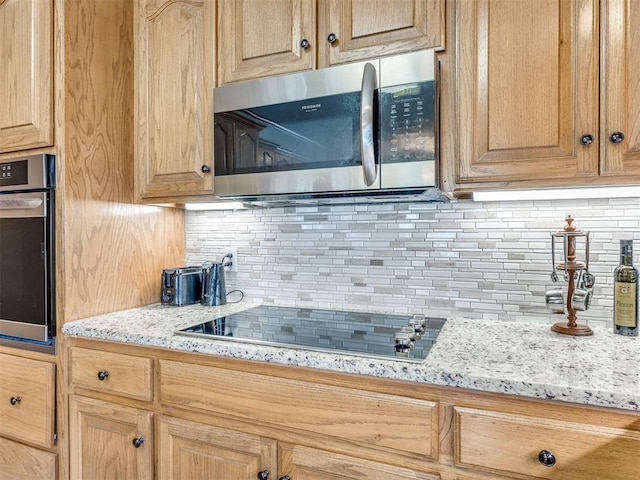 1405 Cambridge Ct, Shawnee, OK 74804 - kitchen with appliances with stainless steel finishes, tasteful backsplash, light stone countertops, and light brown cabinets