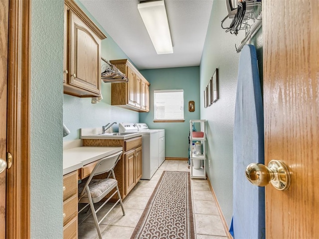 1405 Cambridge Ct, Shawnee, OK 74804 - washroom with cabinet space, washer and dryer, light tile patterned flooring, and a textured wall
