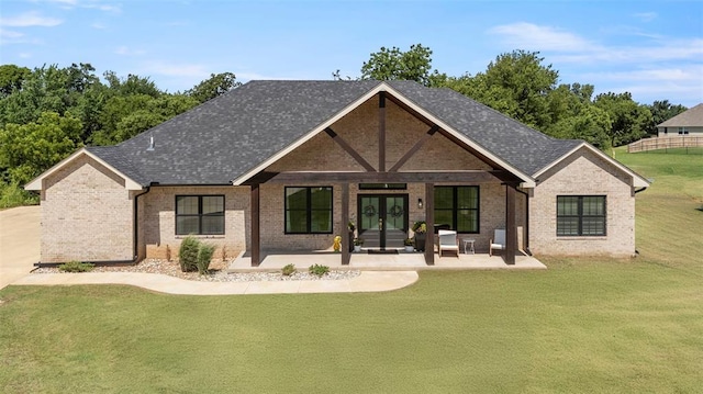 1074 Fawn Meadow Dr, Blanchard, OK 73010 - back of property with french doors, a yard, brick siding, and roof with shingles