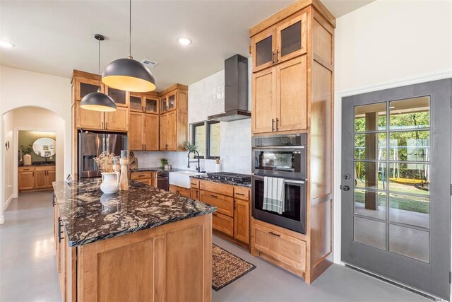 1074 Fawn Meadow Dr, Blanchard, OK 73010 - kitchen with stainless steel appliances, wall chimney exhaust hood, decorative backsplash, dark stone counters, and a center island
