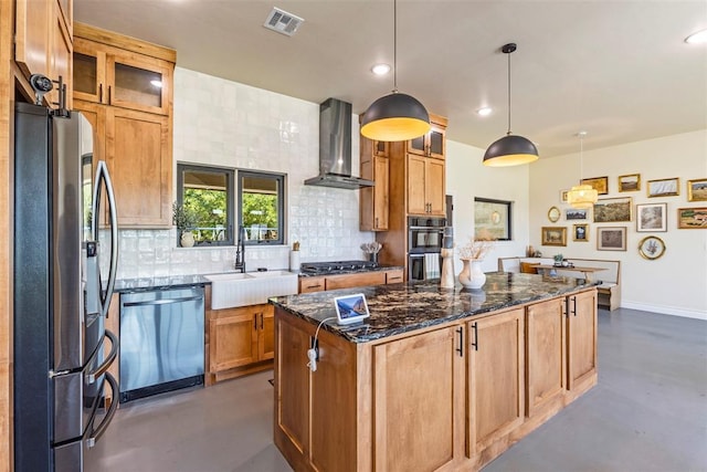 1074 Fawn Meadow Dr, Blanchard, OK 73010 - kitchen featuring appliances with stainless steel finishes, wall chimney range hood, finished concrete floors, a center island, and backsplash