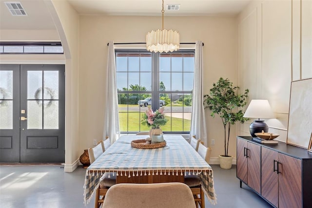 1074 Fawn Meadow Dr, Blanchard, OK 73010 - dining space featuring french doors, finished concrete floors, a chandelier, and healthy amount of natural light