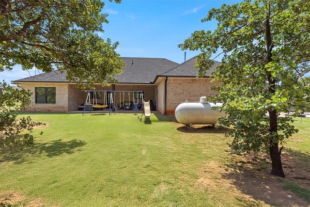1074 Fawn Meadow Dr, Blanchard, OK 73010 - rear view of house featuring brick siding, a shingled roof, and a lawn