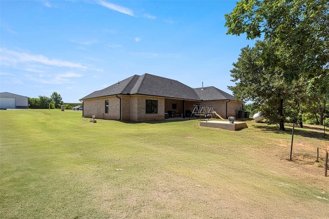 1074 Fawn Meadow Dr, Blanchard, OK 73010 - rear view of property featuring a patio, a yard, brick siding, and a garage