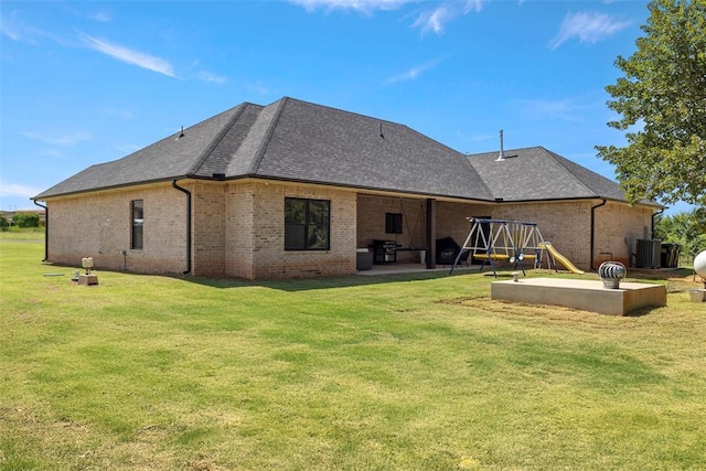 1074 Fawn Meadow Dr, Blanchard, OK 73010 - back of house with brick siding, a patio area, a yard, and a playground