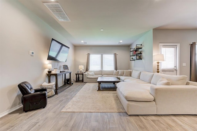 10409 NW 25th St, Yukon, OK 73099 - living room featuring wood finished floors and healthy amount of natural light
