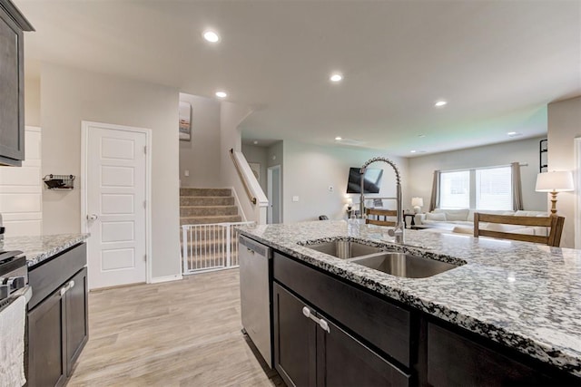 10409 NW 25th St, Yukon, OK 73099 - kitchen featuring stainless steel appliances, light stone counters, light wood-type flooring, open floor plan, and recessed lighting