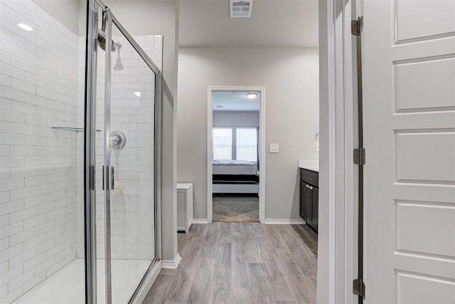 10409 NW 25th St, Yukon, OK 73099 - full bath featuring a stall shower, wood finished floors, vanity, and connected bathroom