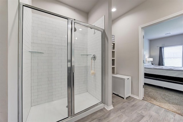 10409 NW 25th St, Yukon, OK 73099 - bathroom with ensuite bathroom, a stall shower, wood finished floors, and recessed lighting