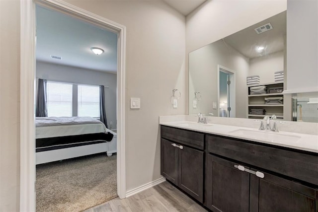 10409 NW 25th St, Yukon, OK 73099 - ensuite bathroom with wood finished floors and double vanity