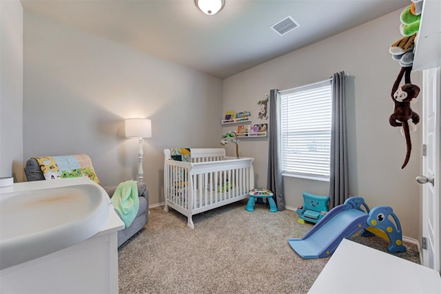 10409 NW 25th St, Yukon, OK 73099 - carpeted bedroom featuring baseboards and a nursery area