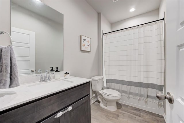10409 NW 25th St, Yukon, OK 73099 - full bathroom featuring vanity, wood finished floors, and a shower with shower curtain