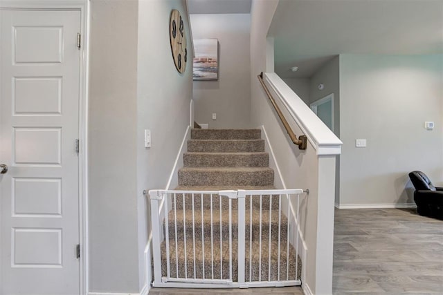 10409 NW 25th St, Yukon, OK 73099 - stairs featuring wood finished floors and baseboards