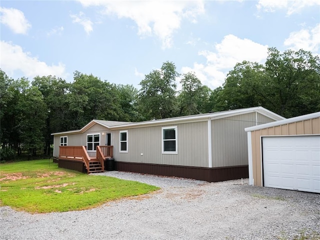 16940 Wildwood Dr, Lexington, OK 73051 - manufactured / mobile home featuring a deck, gravel driveway, and a front lawn