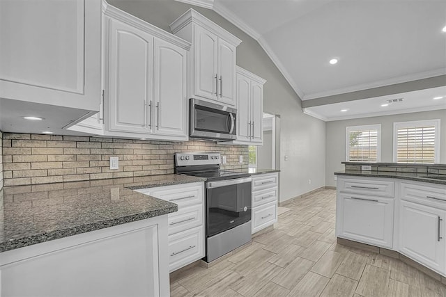 517 N Quail Run, Altus, OK 73521 - kitchen featuring appliances with stainless steel finishes, vaulted ceiling, ornamental molding, white cabinets, and tasteful backsplash