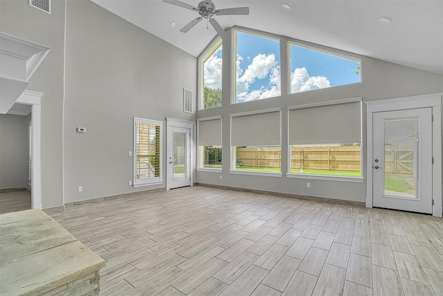 517 N Quail Run, Altus, OK 73521 - unfurnished living room with a ceiling fan, high vaulted ceiling, plenty of natural light, and wood tiled floors